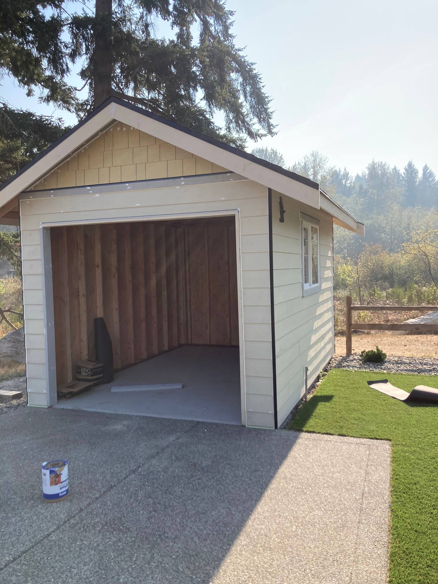 Detached garage with lap siding, a shake-shingle gable, and white corner trim