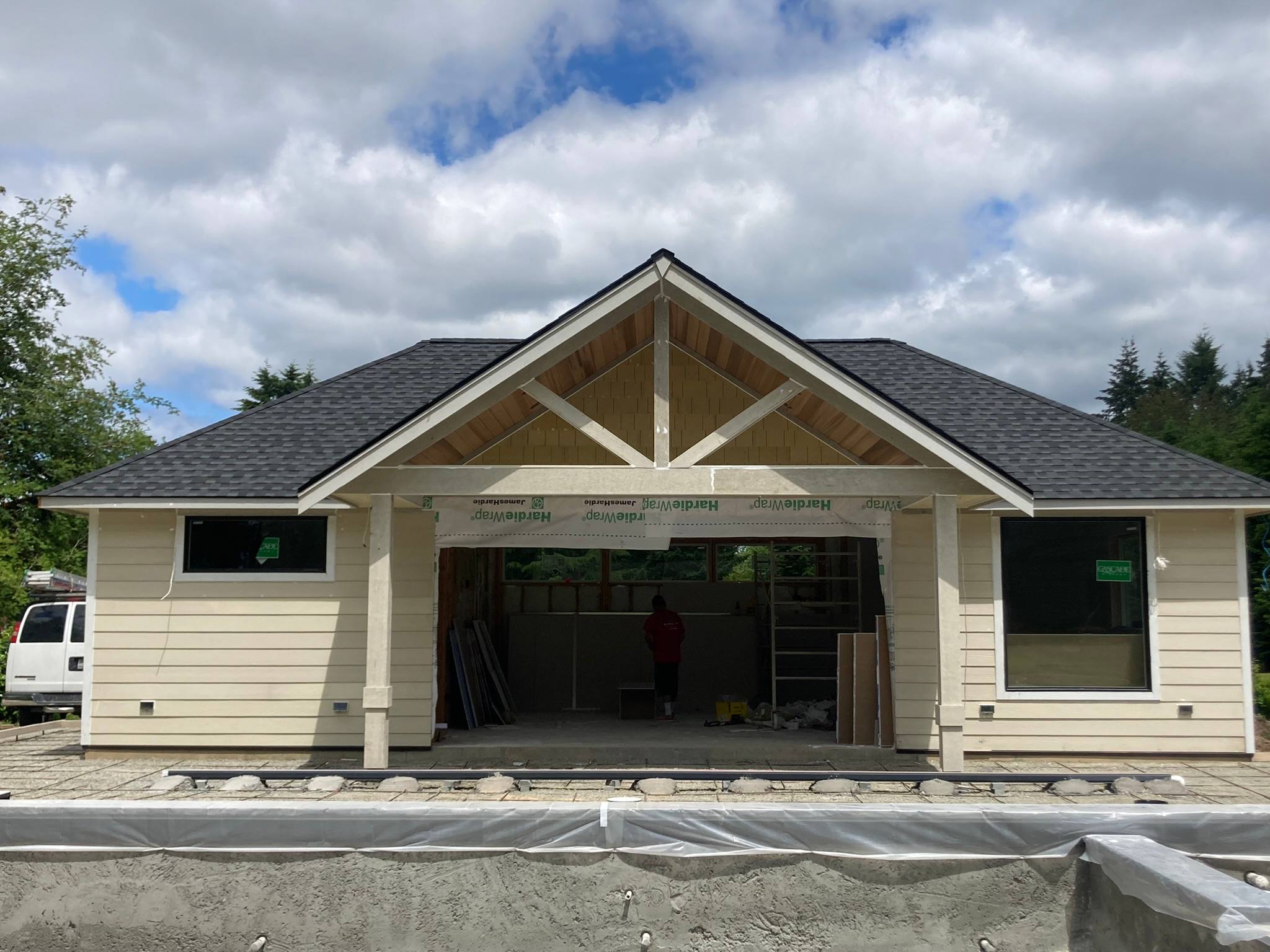 Single-story home with lap siding and an exposed timber truss over the front gable